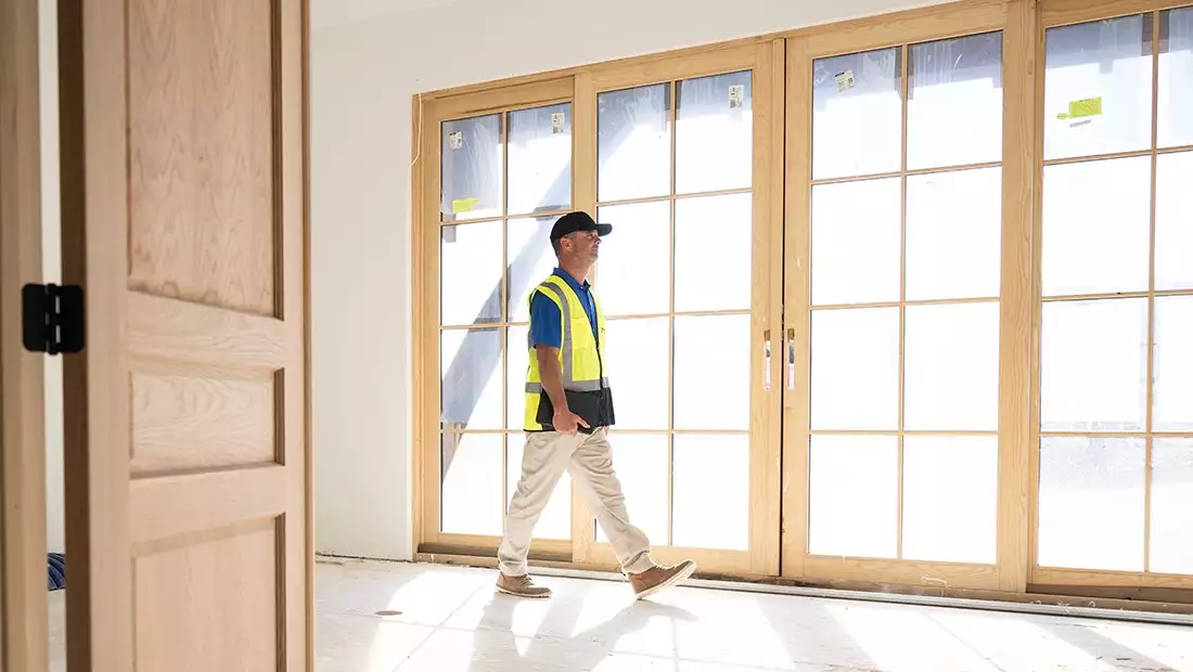 BFS Worker Walking Through House Under Construction