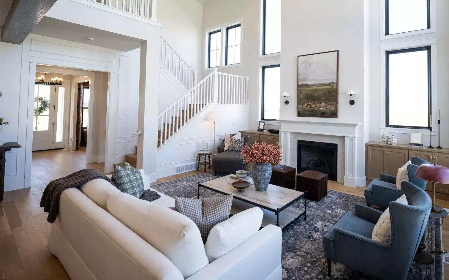 Bright Living Area featuring Fireplace, Large Windows and Staircase
