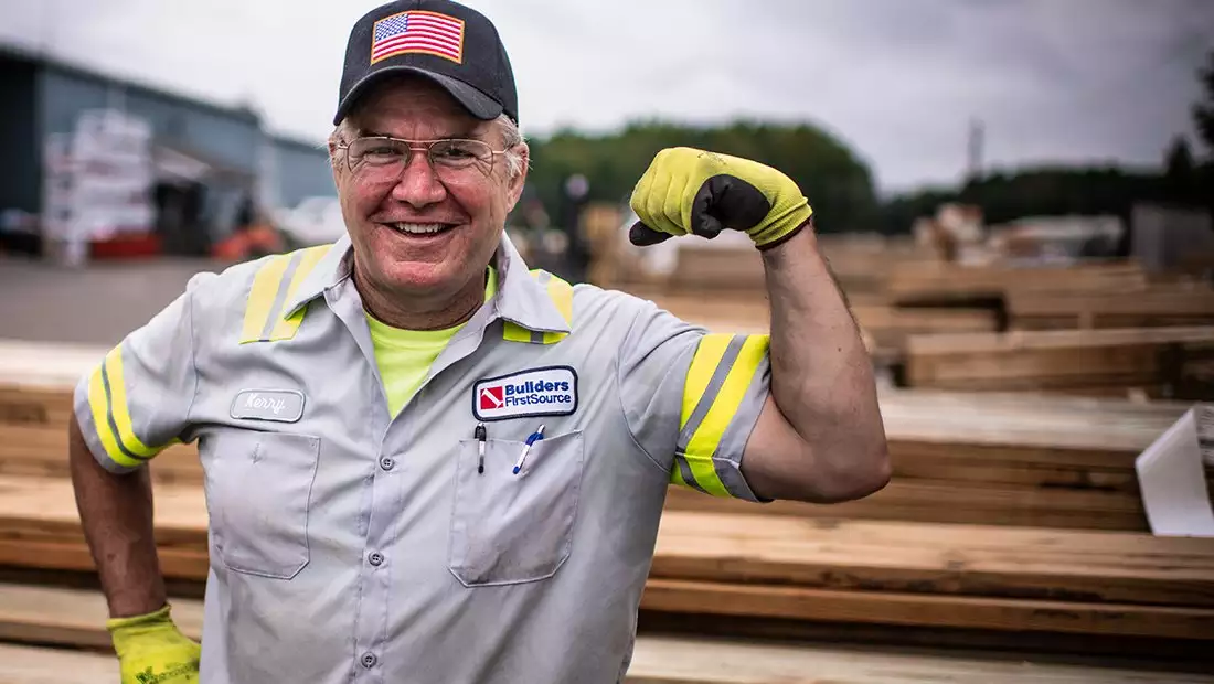 Smiling BFS Worker and Military Veteran with Arm Raised Flexing Muscle